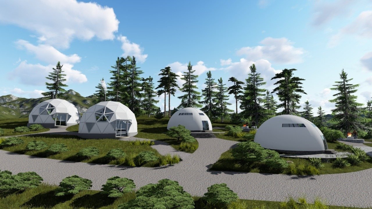Wizualizacja kilku domów kopułowych w zielonym otoczeniu